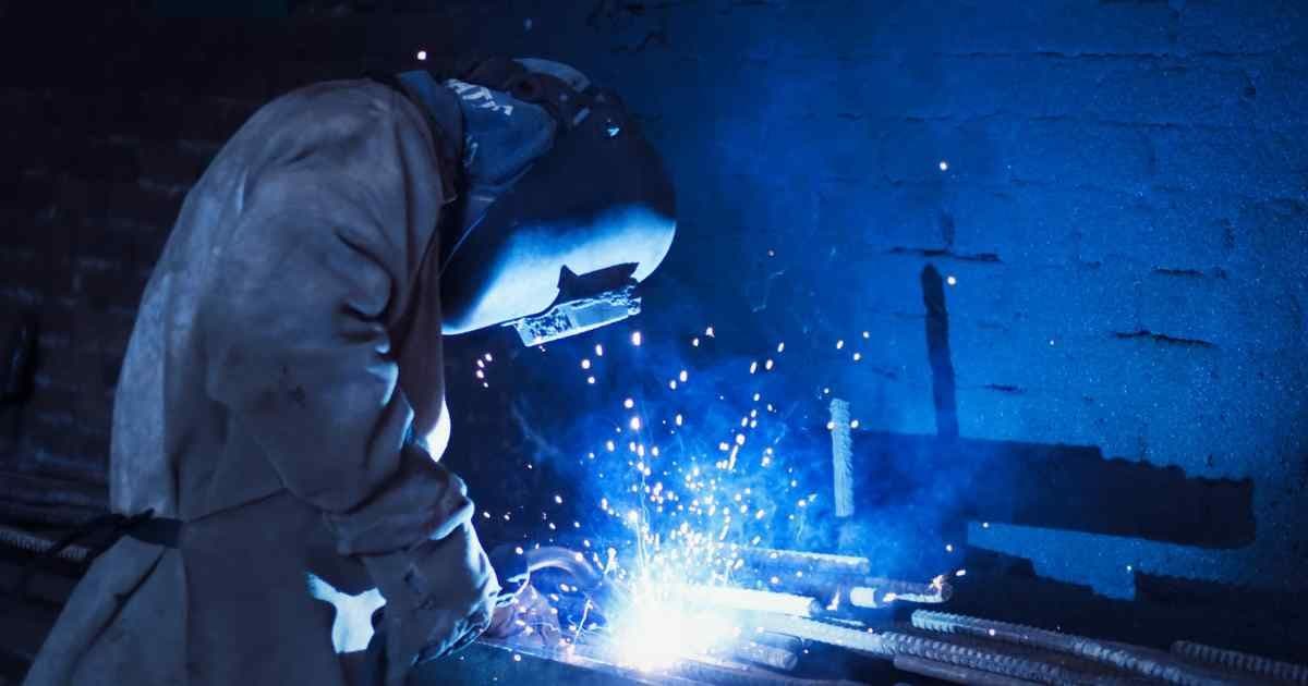 Welder salary in Canada 2026 — certified welder working on industrial pipeline in Alberta