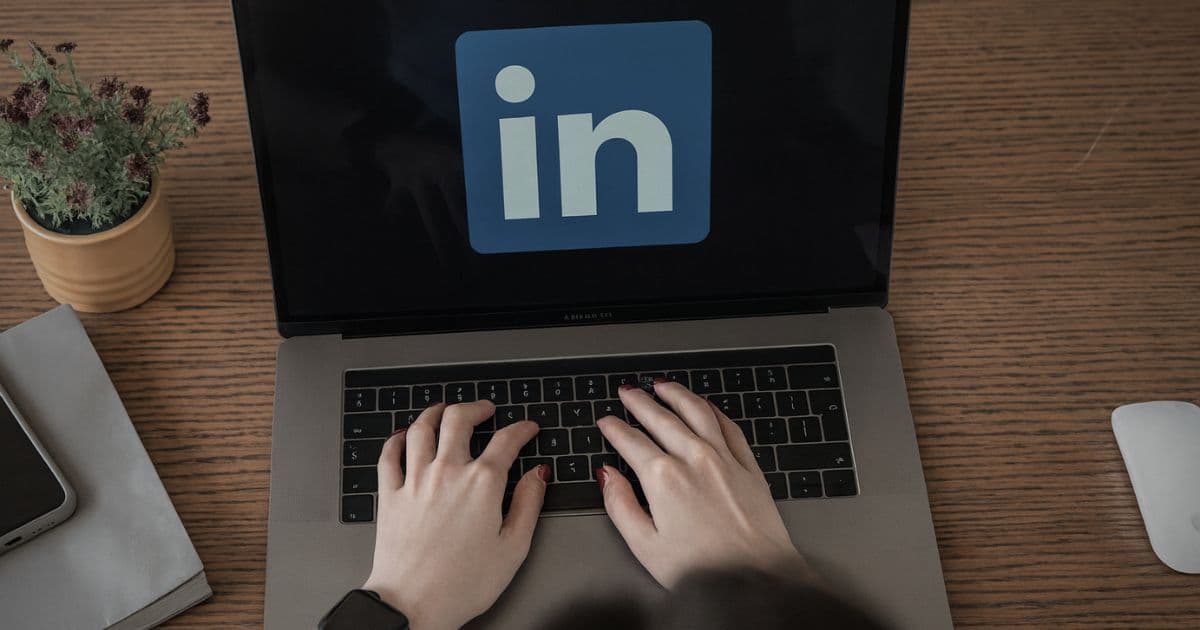 Person typing on a laptop with the LinkedIn logo on screen, highlighting how references can be shared through LinkedIn instead of resumes.