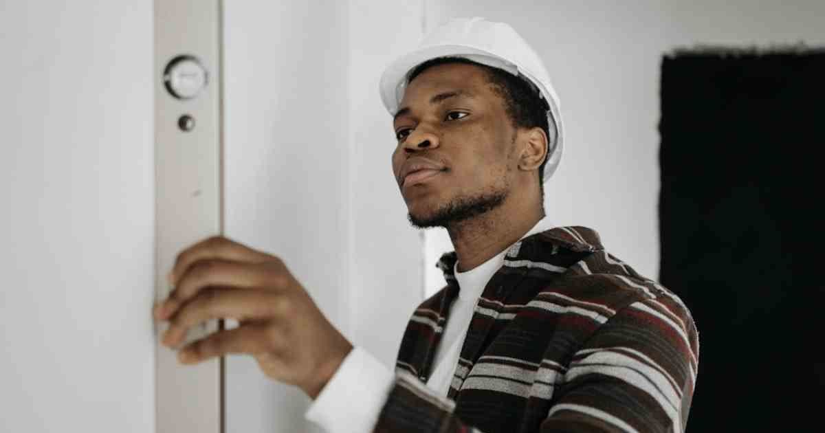 trade-person-measuring-wall-after-being-hired-with-new-resume