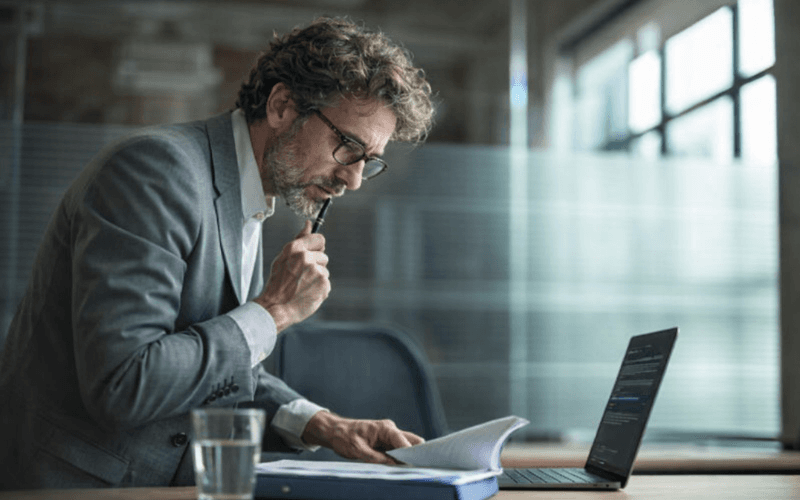 Financial professional reviewing career transition documents after Citigroup layoffs in modern office setting
