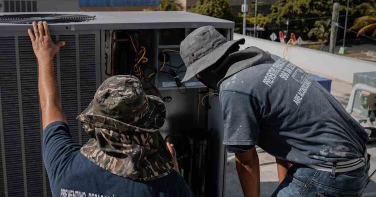 Two HVAC Techs inspecting a machine after a successful job application/resume
