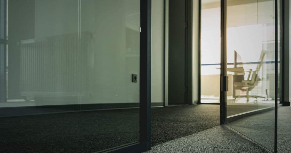 Job seeker researching a company on Glassdoor, sitting at a desk with a laptop open in a home office setting