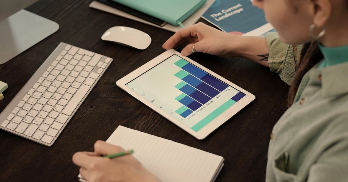 Professional digital marketing manager reviewing analytics dashboard and campaign performance metrics in modern Canadian office