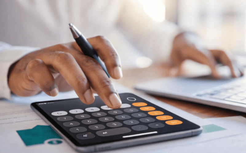 Job candidate reviewing an unpaid interview assignment on a laptop while deciding how to respond professionally